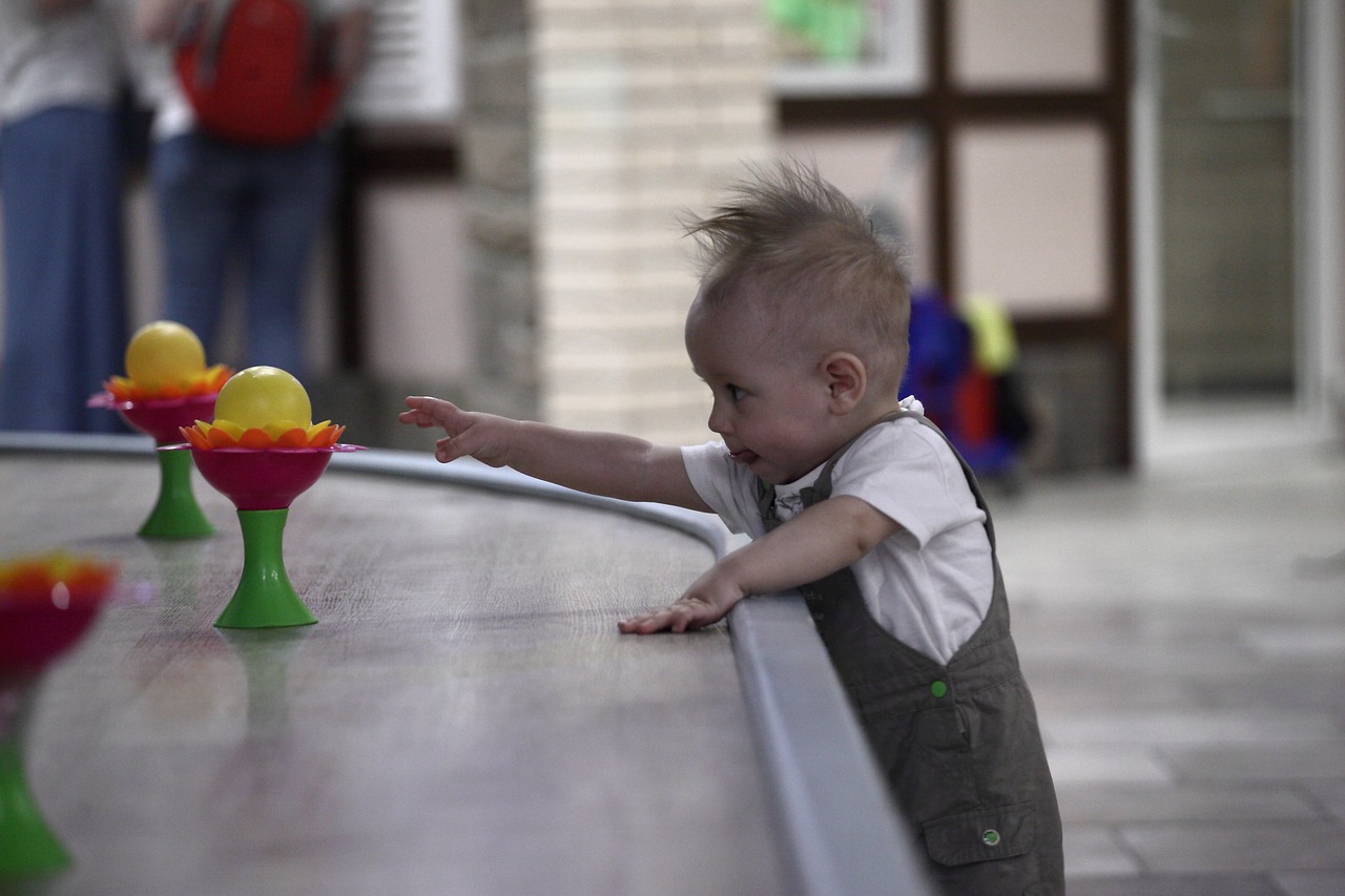 Baby determined to reach the toy